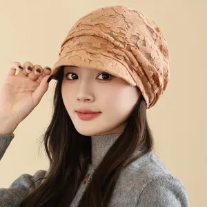 Detail close-up view of a stylish women lace peaked cap, breathable hollow design, beige.