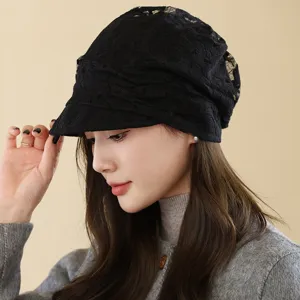 Detailed view of the black lace breathable newsboy cap, showcasing delicate floral hollow patterns.