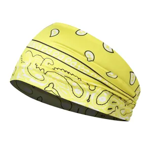 Detailed view of yellow paisley athletic headband, elastic moisture wicking sweatband for sports.