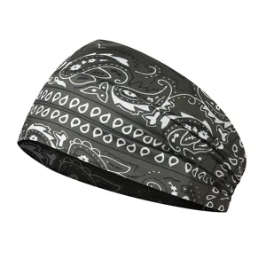 Detailed view of the dark green paisley print elastic sports headband for yoga and running.
