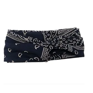 Detailed shot of the navy blue paisley headband with a twisted knot design, classic print style.