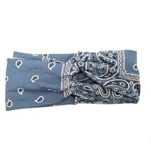 Blue paisley print twist headband detail, vintage fabric hair accessory close up.