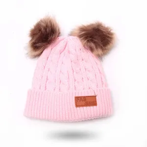 Pink knitted baby beanie detail, double pom-pom winter hat, soft warm children knitwear cap
