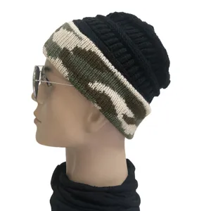 Close-up detail shot of the black knit beanie with camouflage brim worn by a mannequin.