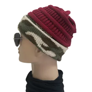 Detailed side view of winter warm knitted beanie hat with camo brim and red ribbed top.