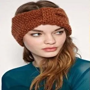 Detail view of a warm winter knitted headband for women, stylish brown crochet hair accessory.
