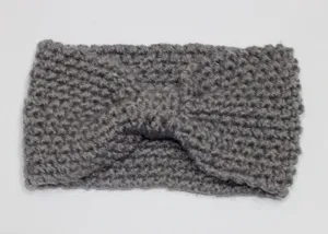 Detail shot of grey knit headband, soft textured winter hair accessory, cozy fabric close up