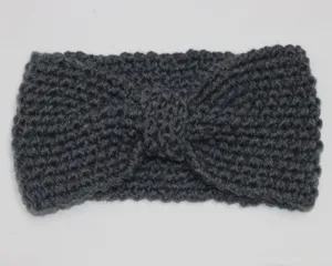 Detail view of the dark grey knitted winter headband, showing its cozy texture and knot.