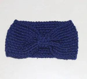 Close-up detail of the dark blue knitted hairband showing texture and bowknot design.