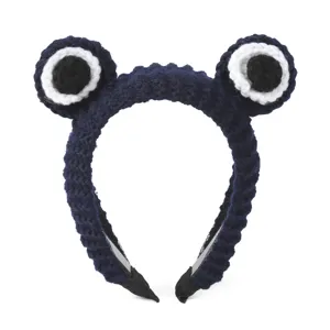 Detailed view of dark blue crochet cartoon eye headband, cute wool knit hair accessory.