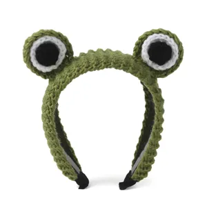 Detailed view of cute green crochet frog hair hoop with big eyes, soft plush design for daily wear.