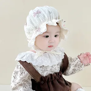 Close-up details of the lovely infant cotton bonnet with delicate ruffles and sweet bunny prints.