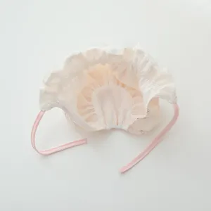 Cute infant baby bonnet with ruffles and ties, soft pink cotton hat for newborn girls.