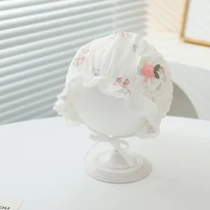 Cute infant cotton hat with lace brim and floral embroidery, soft breathable baby headwear.