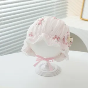 Cute pink baby infant bonnet hat with bow print and lace brim for sweet daily wear.