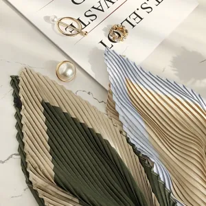 Close-up detail of pleated scarf fabric with chic design, elegant texture and fashion props.