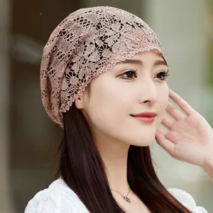 Gros plan detail bonnet dentelle ete femme, couverture tete creuse marron respirante.