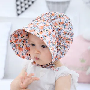 Infant floral sun hat detail showing delicate print, soft cotton fabric and wide brim design.
