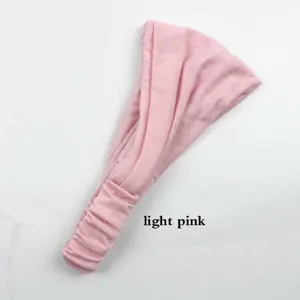 Detail view of the solid color pleated yoga headband in light pink, soft and stretchy fabric.