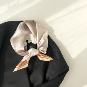 Silk square scarf detail shot showing exquisite sand painting print pattern and smooth texture.