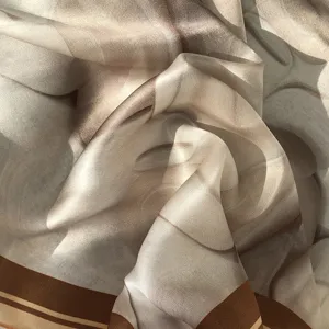 Close-up detail of luxurious milky silk scarf showcasing soft drape and smooth texture.