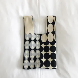 Close-up detail of Japanese style knitted tote bag with black, beige and blue dot pattern.