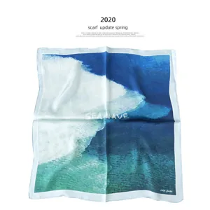 Luxury silk square scarf with artistic blue ocean wave print, elegant neckerchief for women.