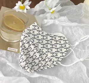 Summer UV protection face mask with black and white geometric pattern detail.