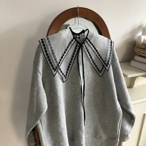 Detachable lace embroidered doll collar layered with classic grey sweatshirt for women daily wear.