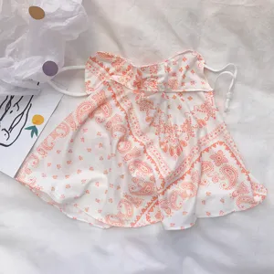 Detailed view of the summer sun protection face mask with orange paisley pattern and ear loops.