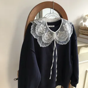 Detailed shot of dark blue sweatshirt with white floral lace embroidered detachable fake collar.