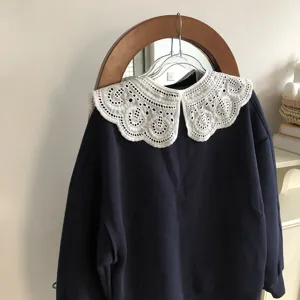 Exquisite white lace embroidered detachable false collar detail shot, elegant floral design.