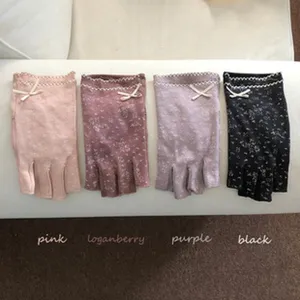 Women knitted fingerless gloves with bow and floral pattern, four color variants available.