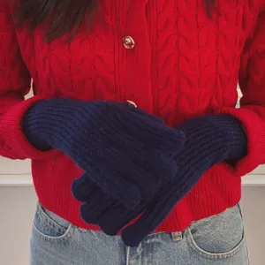 Detail view of solid color knitted gloves, warm winter wool gloves for men and women couple.