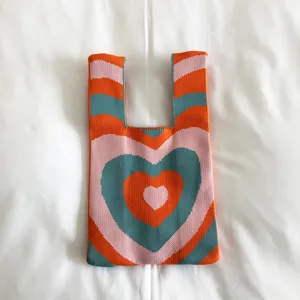 Knitted tote bag with wave heart pattern, cute casual shoulder bag for women daily use.