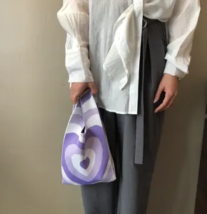 Detailansicht der stylischen violetten Herz-Stricktasche mit einzigartiger Webstruktur.