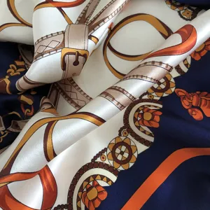 Silk scarf detail featuring classic chain and belt print, premium luxury style square silk wrap.