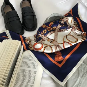 Luxurious silk square scarf with classic equestrian belt print, elegant vintage accessory.