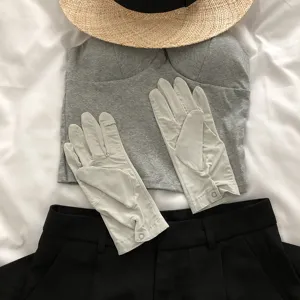 Detail shot of UV protection touchscreen gloves in light grey, perfect for outdoor summer driving.