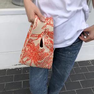 Detailaufnahme der modischen Strick Handtasche mit orangefarbenem Vintage Reiter Muster.
