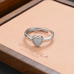 Exquisite heart-shaped stone open ring detail shot, showing delicate silver metal texture.