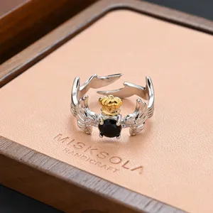 Vintage silver crown wings ring with black stone, detailed retro design for women and girls.