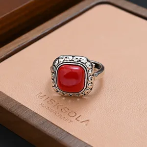 Vintage silver ring with a square red gemstone in a wooden box for women retro chic style.