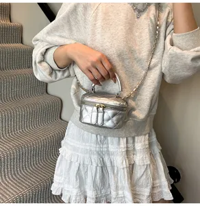 Trendy silver quilted crossbody bag for women, chic chain shoulder bag with top handle.