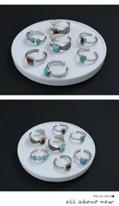Vintage stackable open ring detail featuring turquoise and tiger eye stones on carved silver bands.