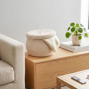 Cotton rope storage basket detail, woven design with lid and white handle for home decor.