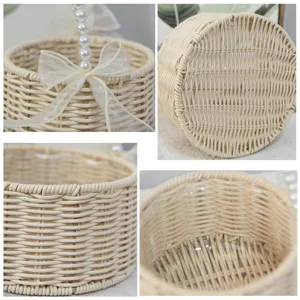 Detailed view of woven rattan basket with pearl handle, perfect for wedding floral decoration.