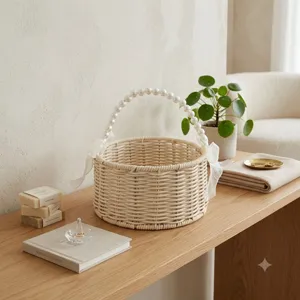 Rattan woven flower basket featuring elegant pearl handle and white bows for wedding decor.