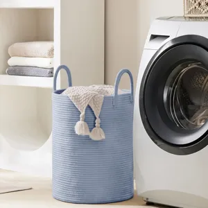 Detailed view of Nordic cotton rope laundry basket with dual handles and tassel decor.