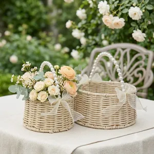 Detail view of woven rattan flower basket with pearl handle and ribbon bow for wedding decor.
